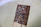Close-up of a protein bar with nuts and seeds on a rustic wooden table.