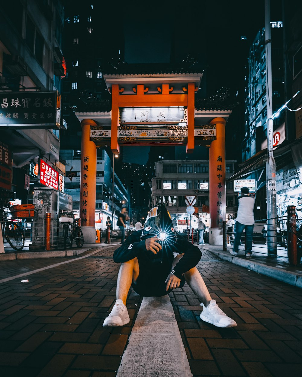 man in white shoes sitting on road