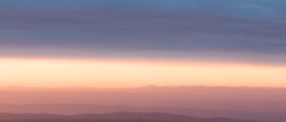 a view of a mountain range at sunset