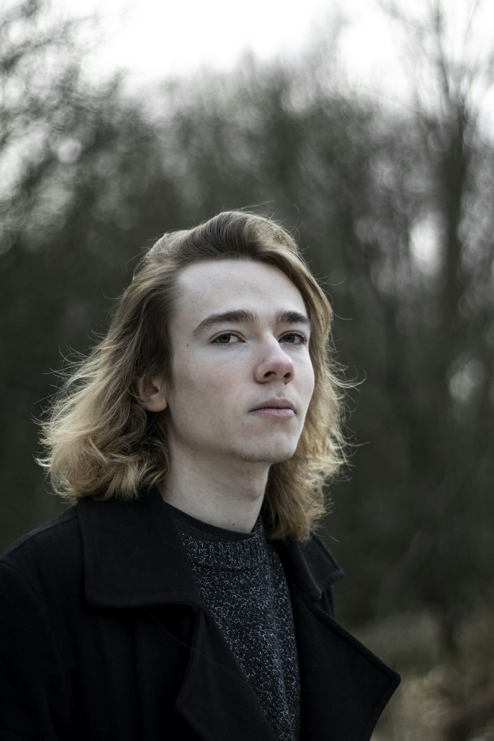 selective focus photography of man wearing black coat