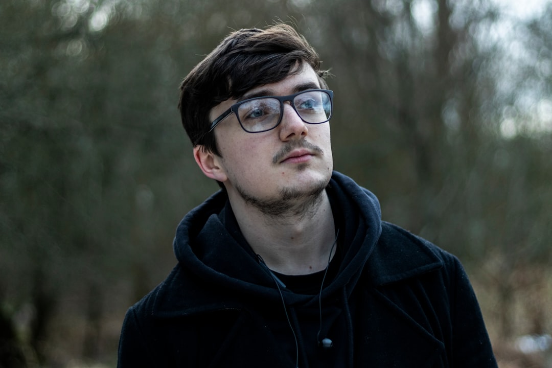 man in black drawstring hoodie with eyeglasses