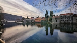 Serene river scene near Rafael with subtle architectural elements harmonizing with the environment