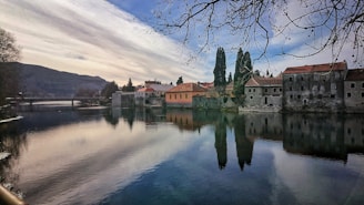 Serene river scene near Rafael with subtle architectural elements harmonizing with the environment