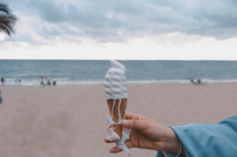 person holding vanilla ice cream