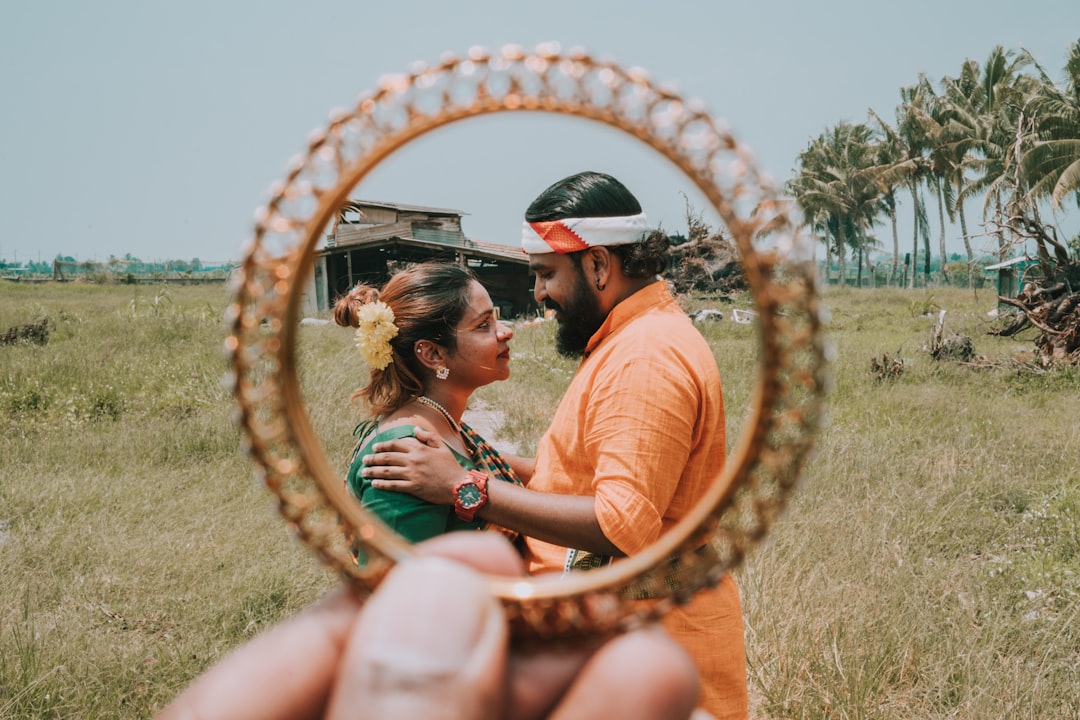 man in orange top facing woman in green dress