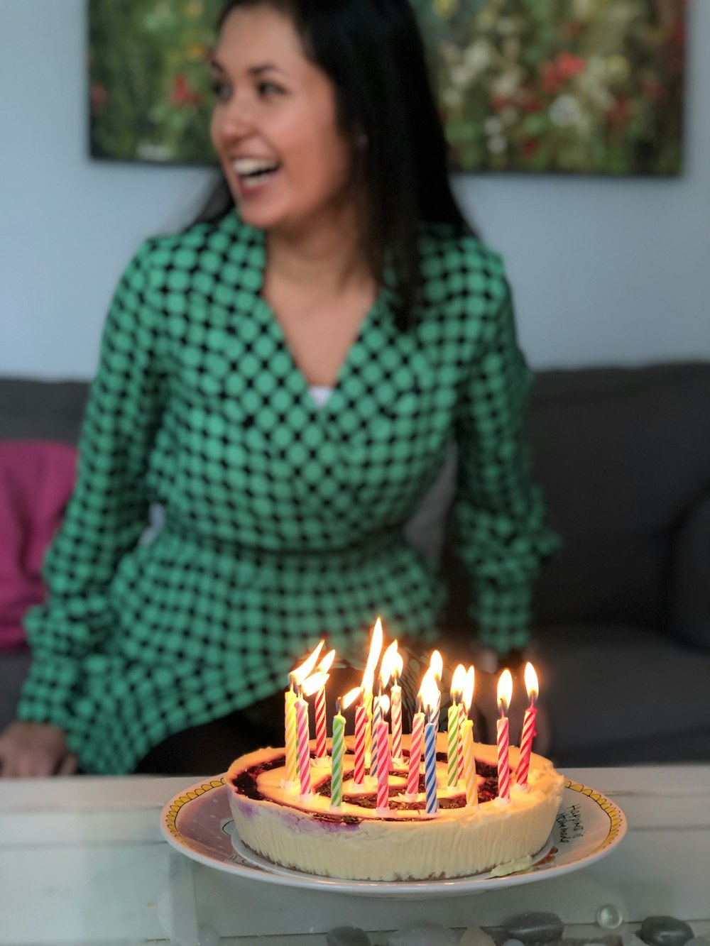 smiling woman in front of cake