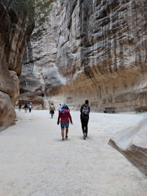 A group of explorers walking through the winding, sculpted passageways of Antelope Canyon.