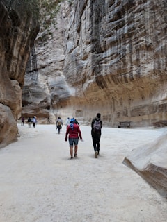 A group of explorers walking through the winding, sculpted passageways of Antelope Canyon.