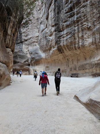 A guide explaining the history of the Talampaya canyon walls to an attentive group of visitors.