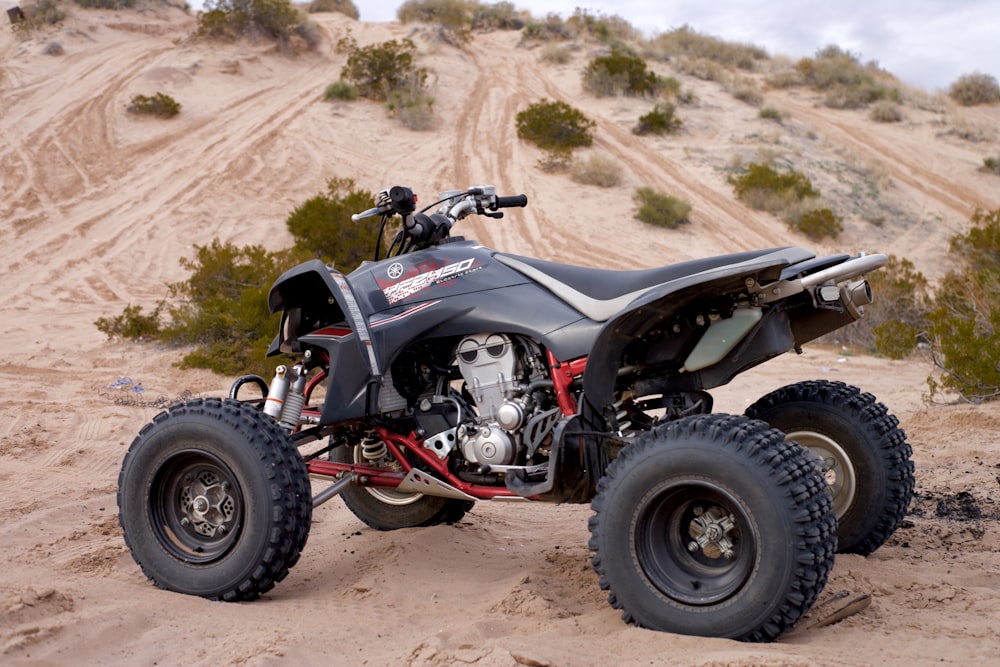 black ATV on brown soil