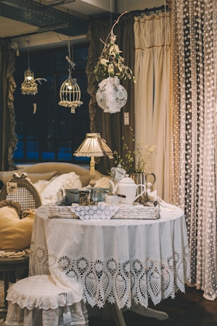 white teapot and cups on white table inside room