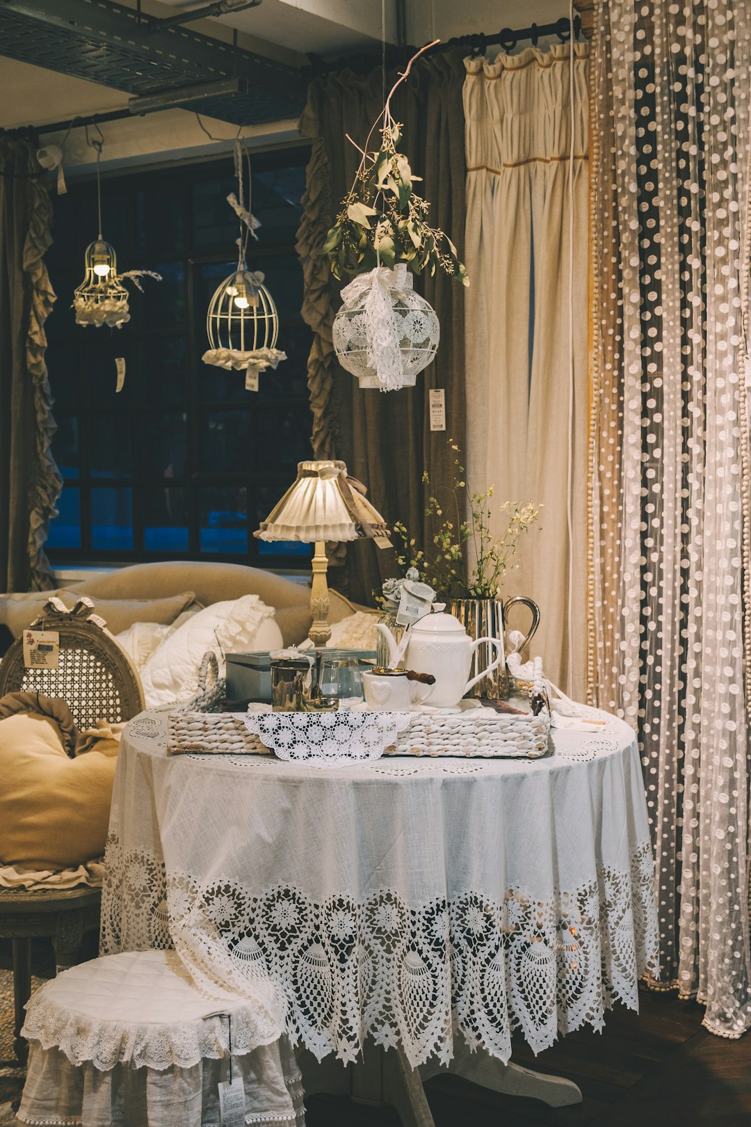  white teapot and cups on white table inside room tablecloth