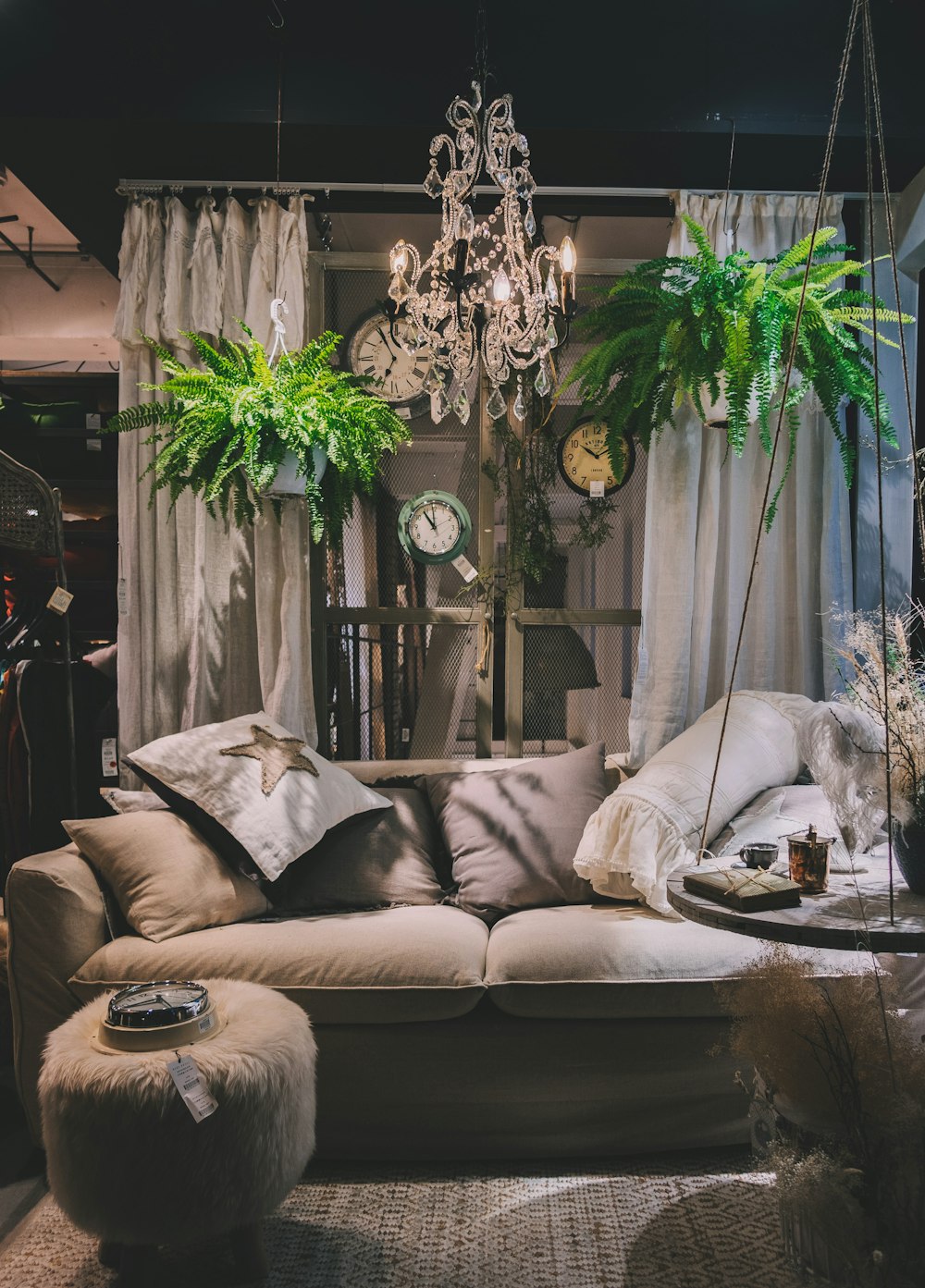 brown sofa under clear glass chandelier