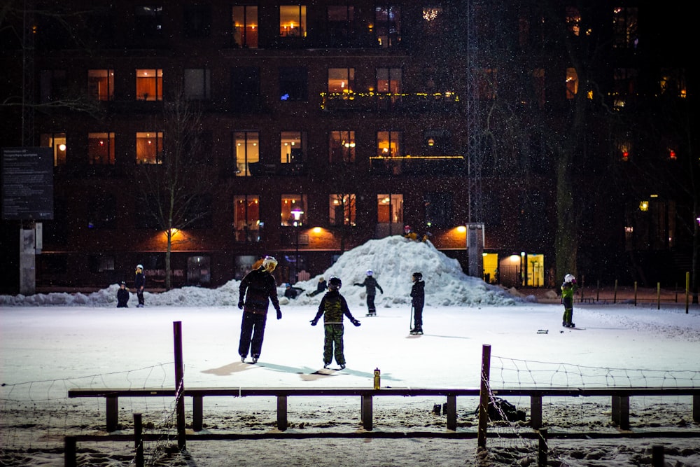 group of boys skating on snow field