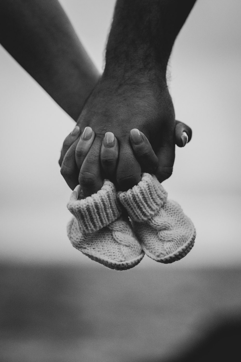 person holding bootees