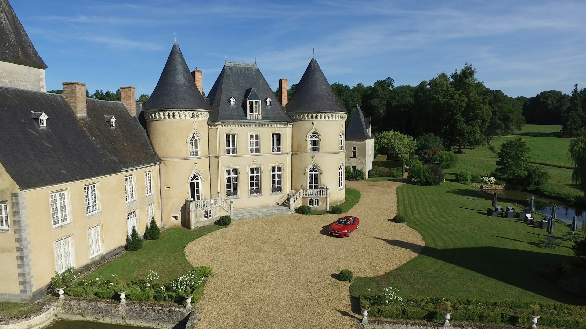 aerial view photography of red vehicle park in front of building