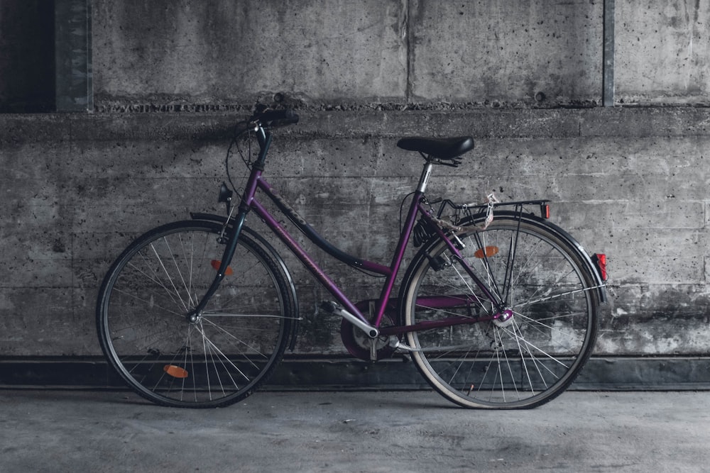 purple and black beach cruiser bicycle
