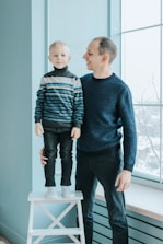 A friendly clinician discussing progress with a smiling parent and child.