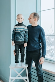 Friendly speech therapist explaining techniques to a smiling child and parent.
