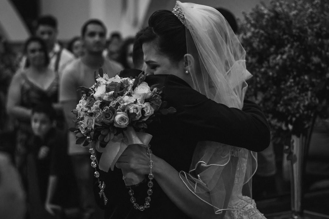 grayscale photo of man and woman hugging