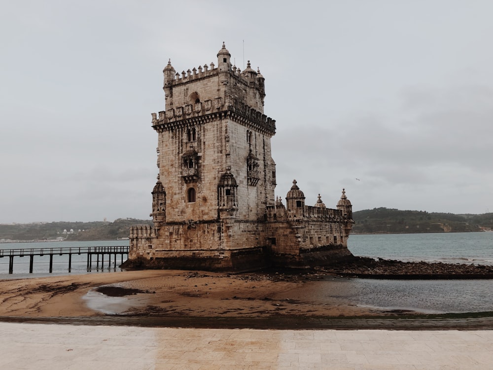 brown concrete building near body of water