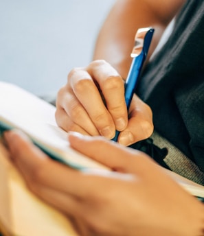 shallow focus photo of person writing