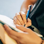 shallow focus photo of person writing