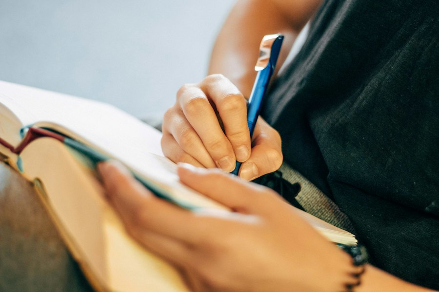 Hand writing notes in an open notebook