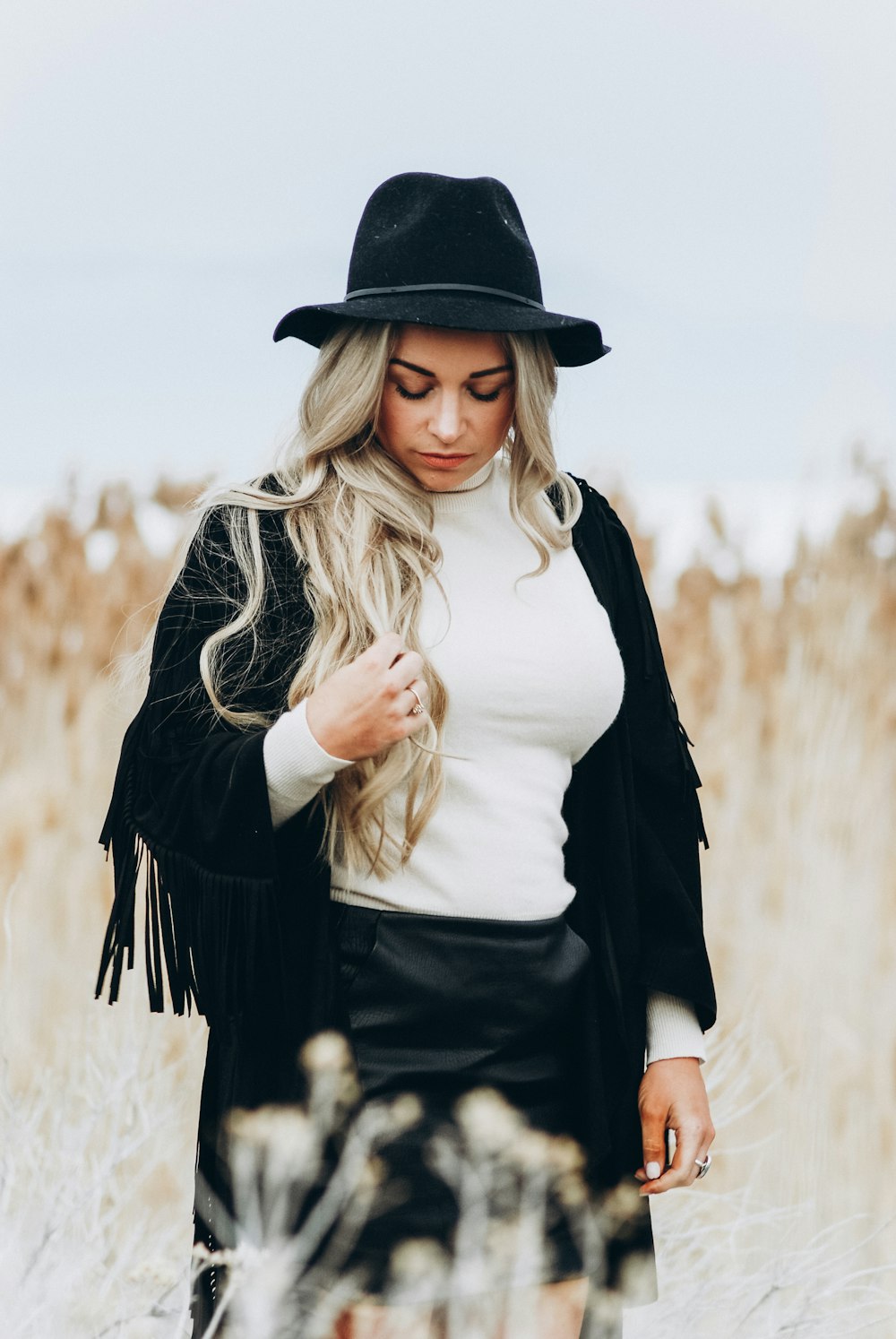 woman in white top in the middle of the field