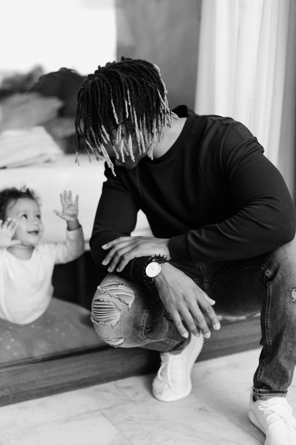 shallow focus photo of man talking to baby