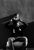grayscale photography of man lifting a girl