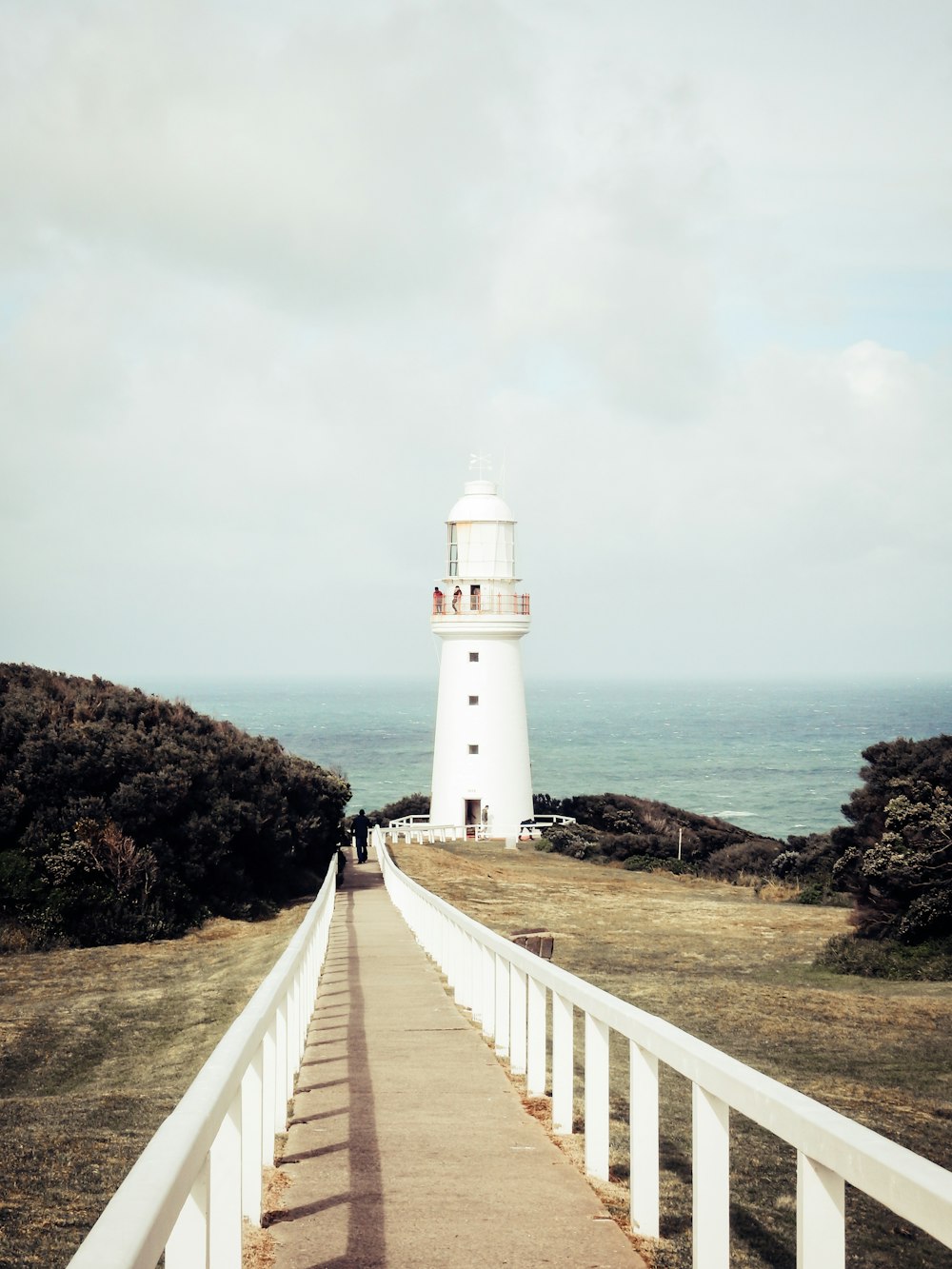 white lighthouse under cloudy sky