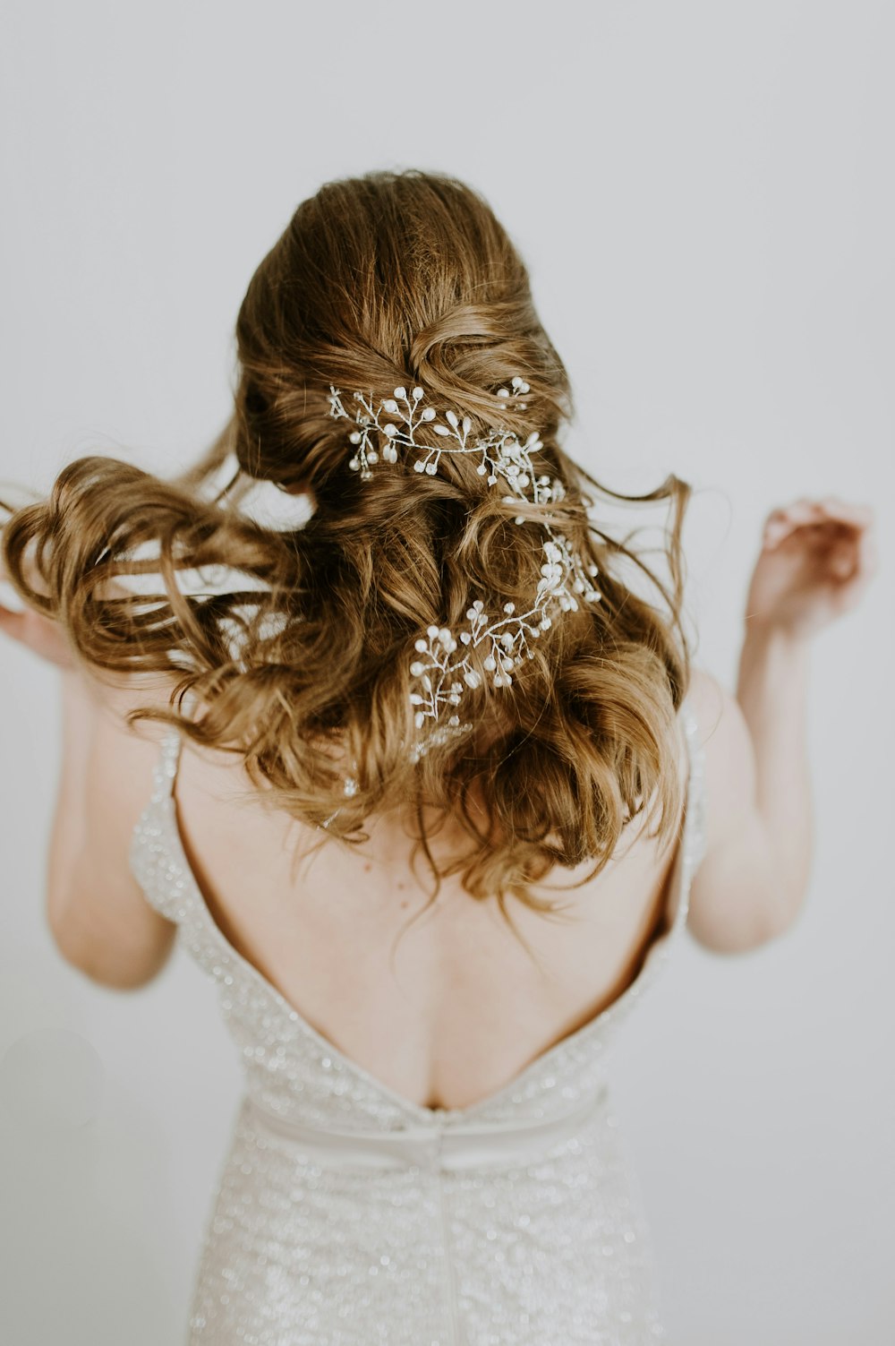 woman in beige open back sleeveless formal dress