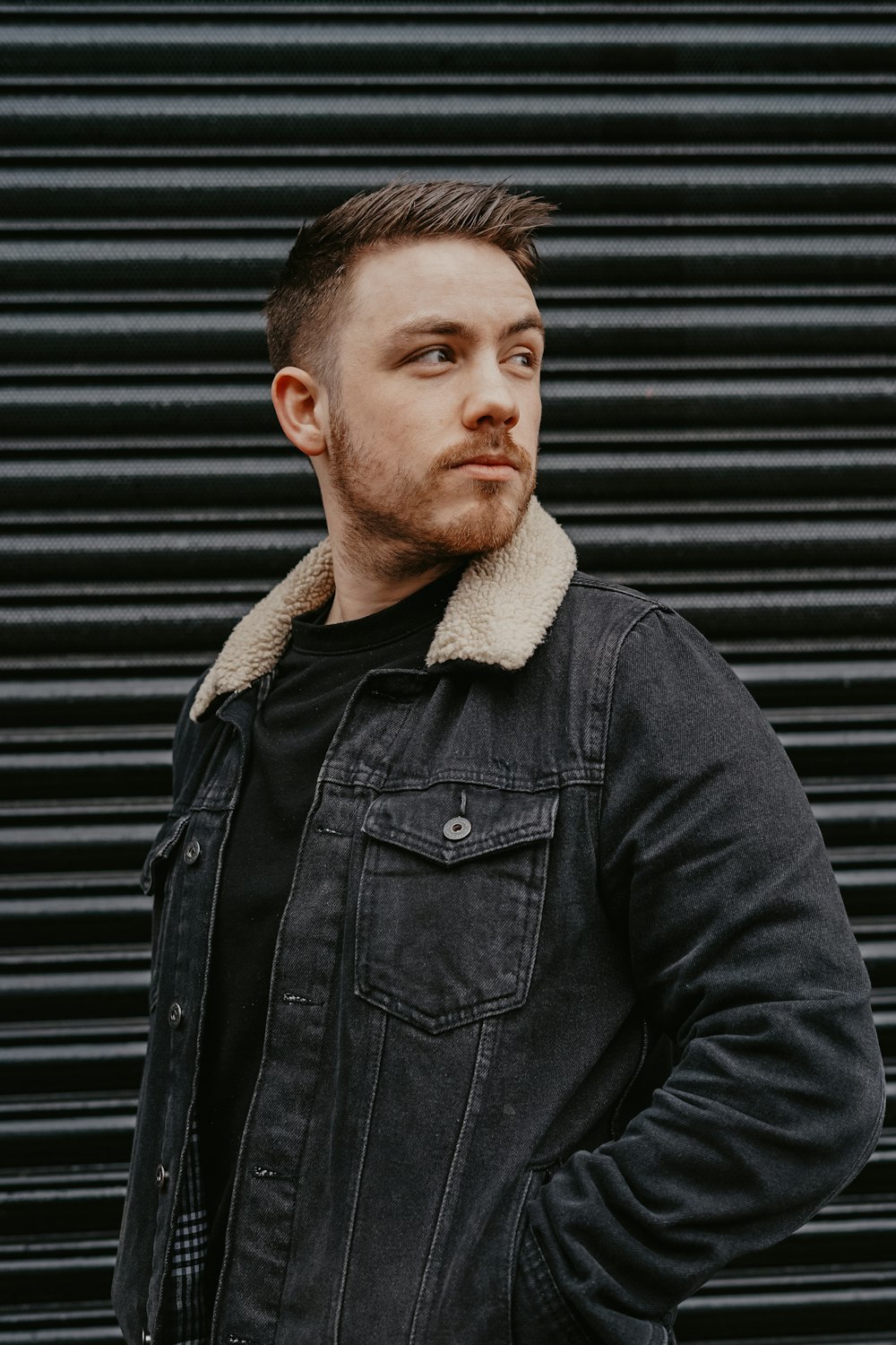 man wearing black denim jacket