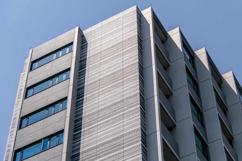 white concrete high-rise building under blue sky