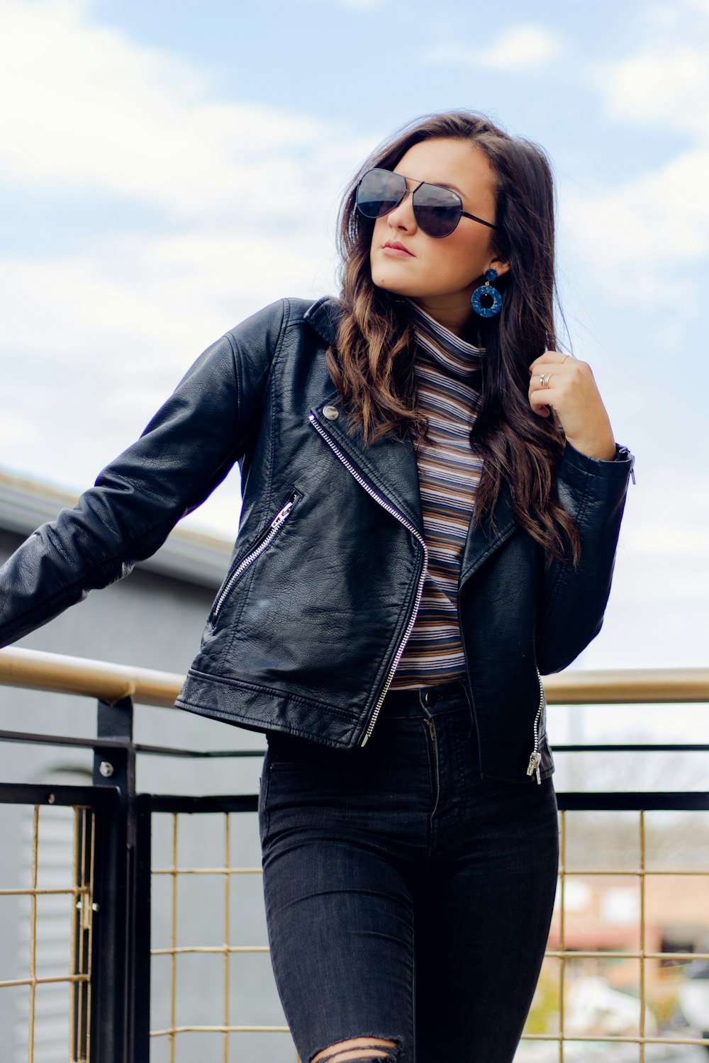 woman standing beside black railing during daytime