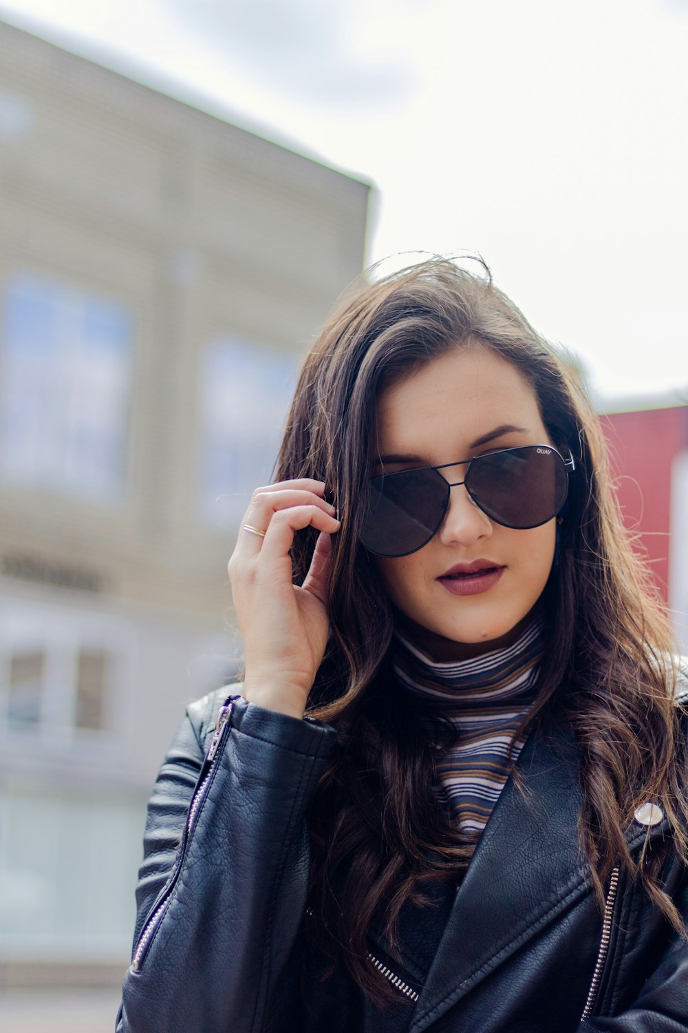 woman holding sunglasses