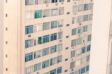 A high-rise apartment building with large windows and city views.