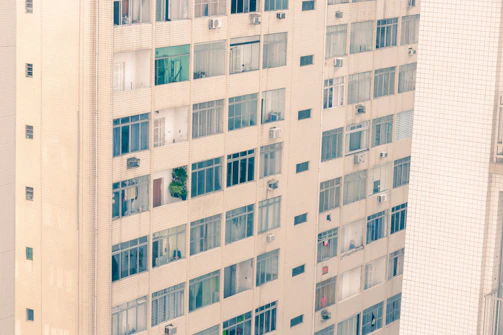 A high-rise apartment building with large windows and city views.