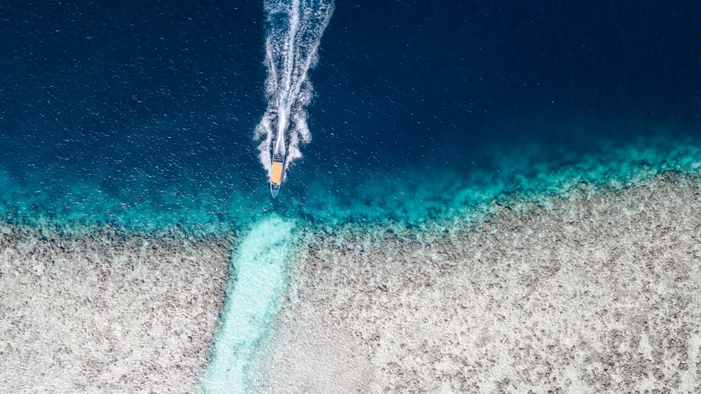 aerial view of boat on blue water