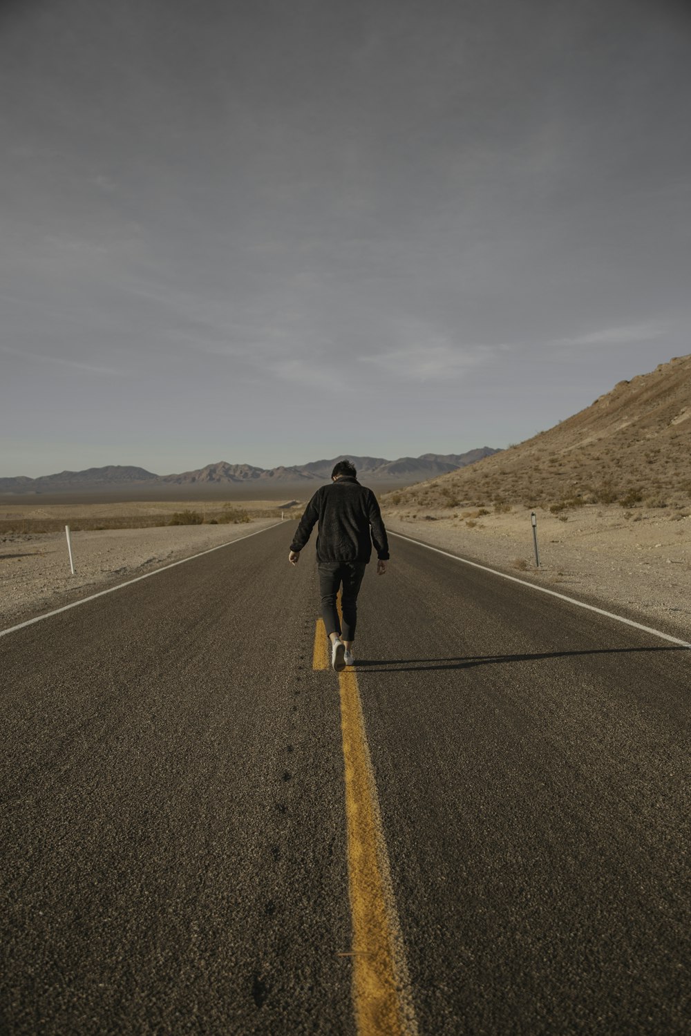 man walking on road