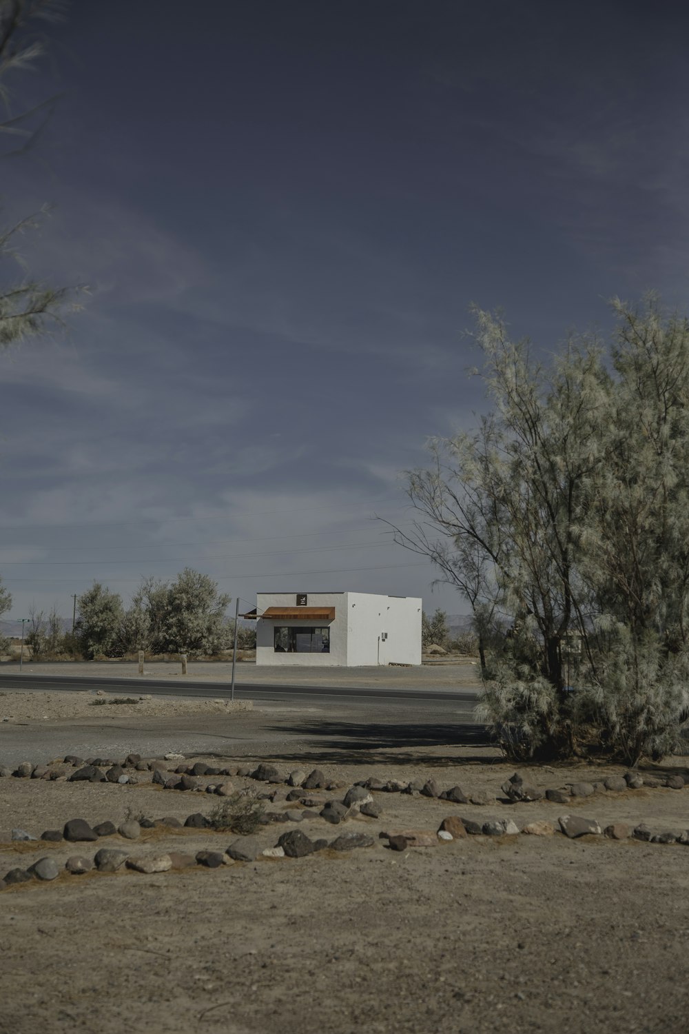 white concrete house near trees during daytime