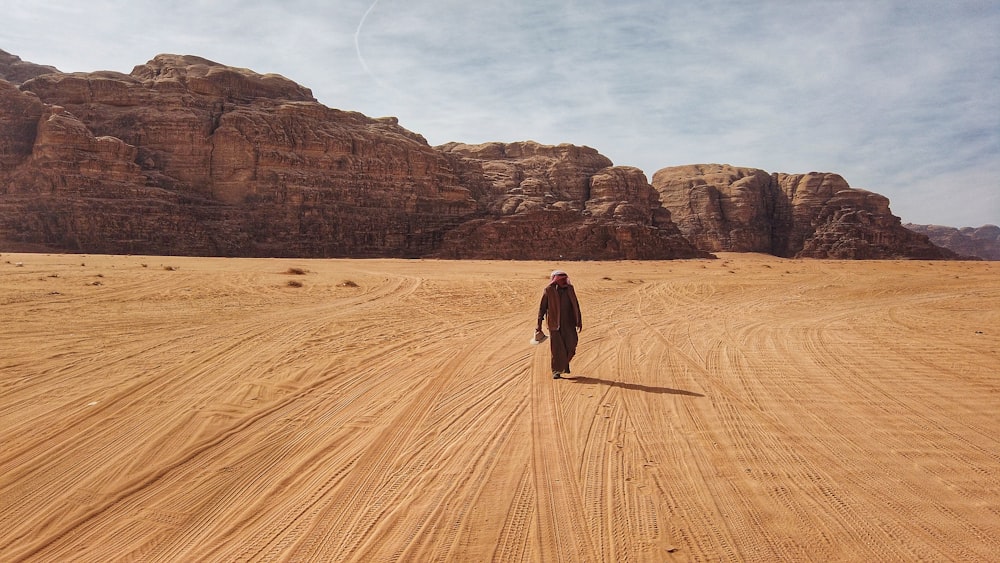 person walking in desert during daytime