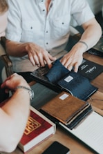 A group of fashion consultants discussing design ideas around a table filled with fabric swatches.