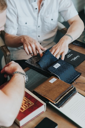 A designer reviewing fabric samples under bright workshop lights.