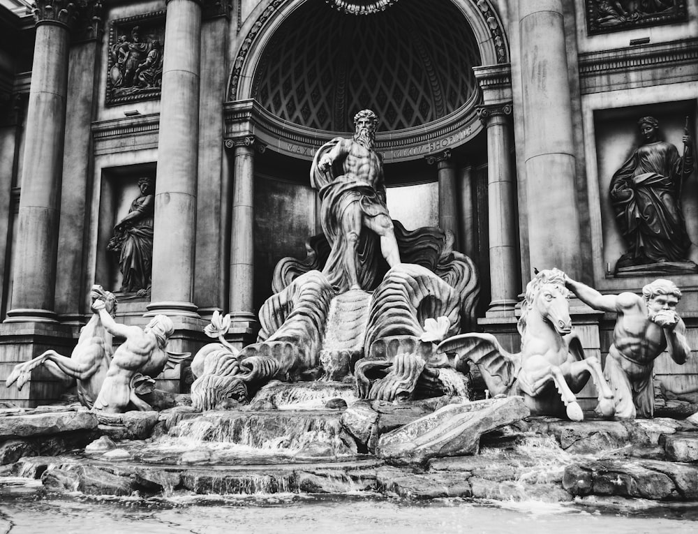 grayscale photography concrete statue of man