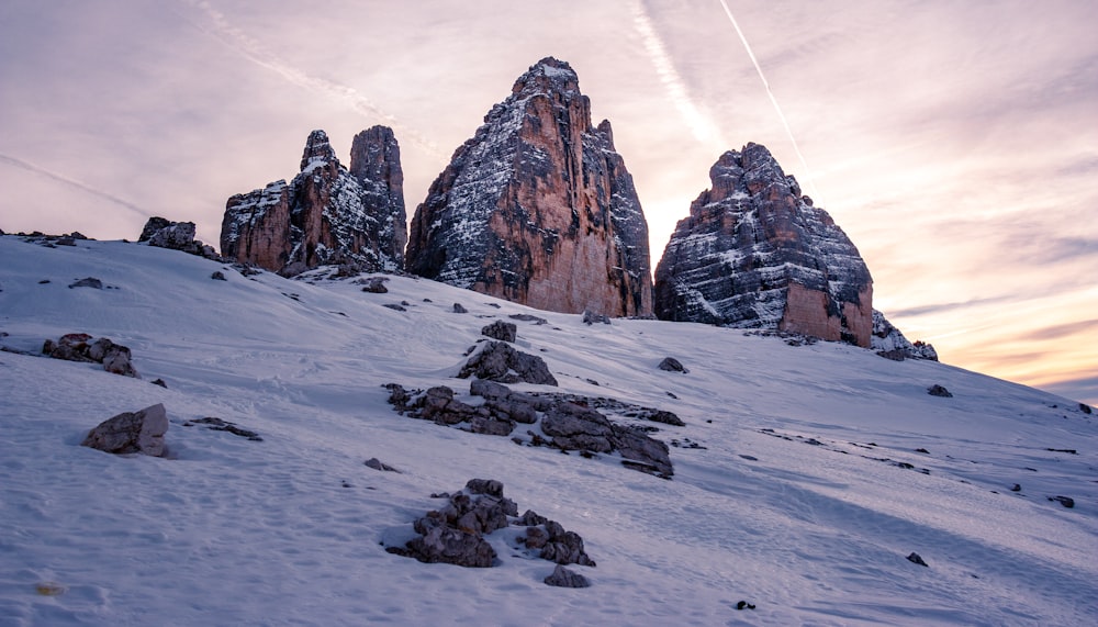 rocky mountain covered with snow during daytime