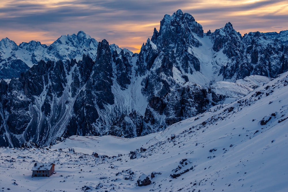 mountain covered with snow under gray sky