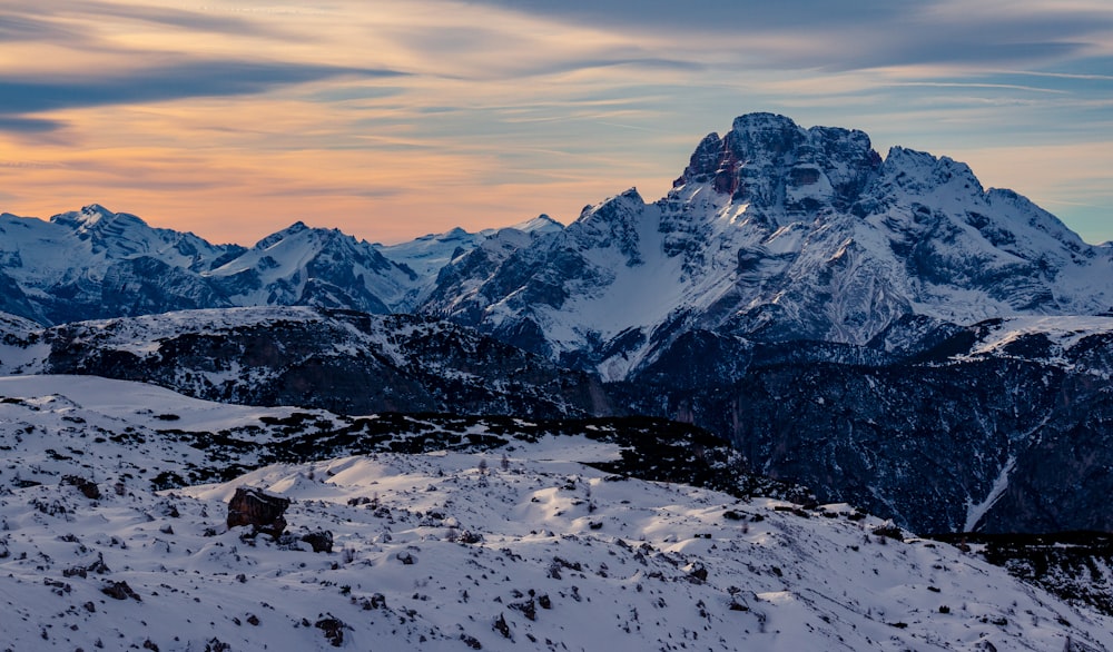 snow covered mountain under gray sky