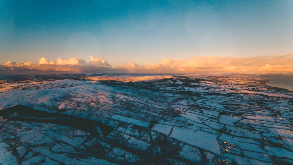 snow covered field under blue sky during daytime